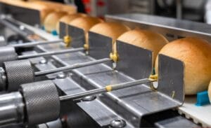 Industrial production line for filling and injecting butter rolls