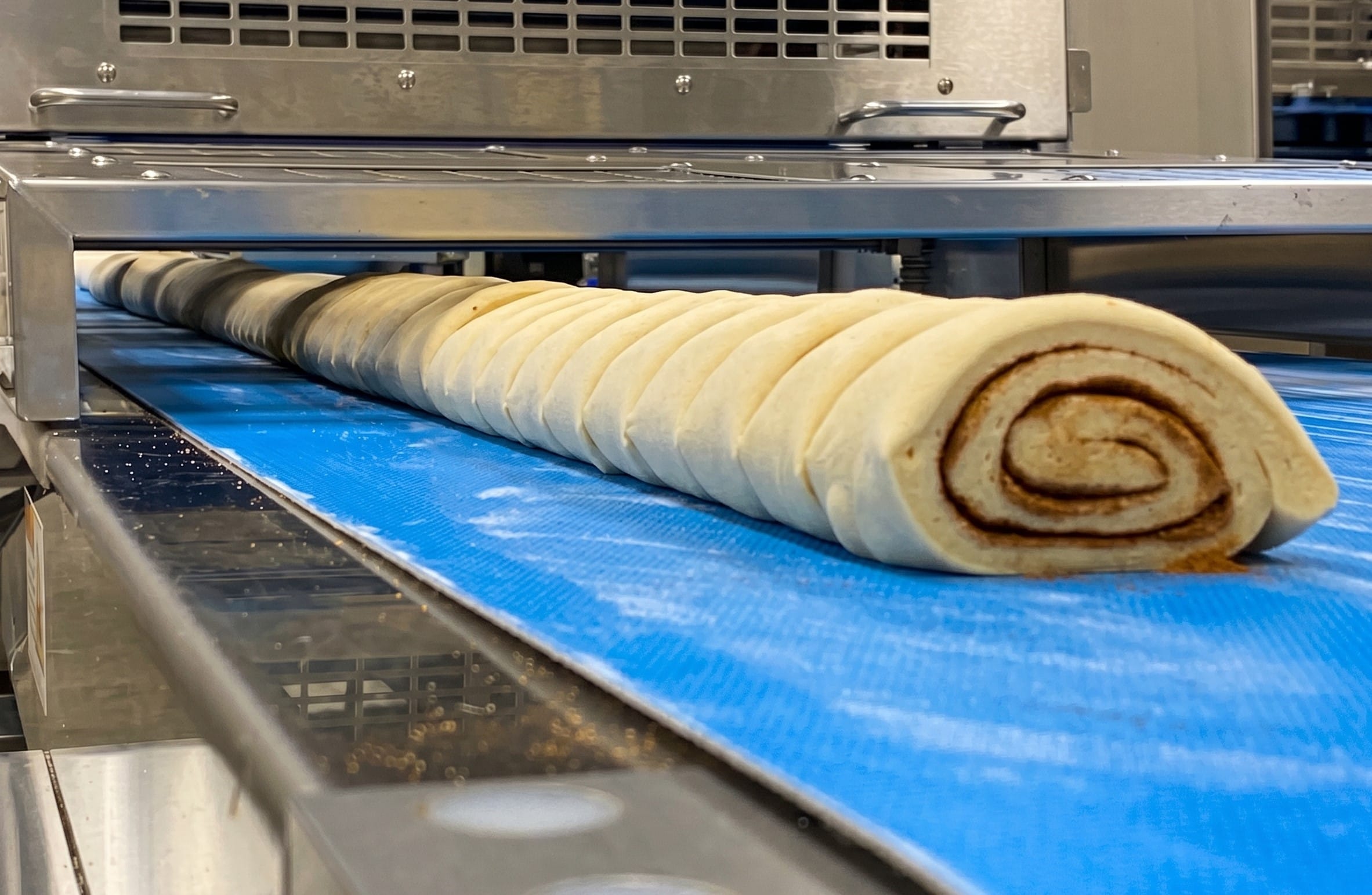 Industrial production line for cinnamon rolls and pastries